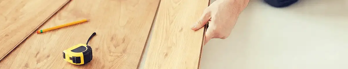 A professional installing wood flooring in Kansas City, KS