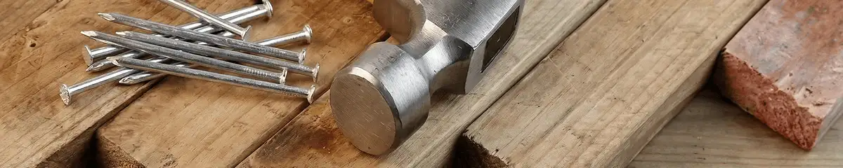 Hammer and nails on hardwood flooring boards in Kansas City, KS