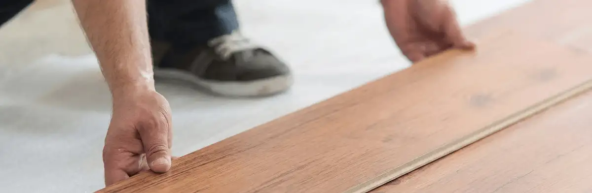 A professional installing laminate flooring in Kansas City, KS
