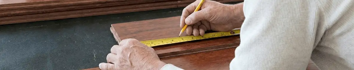 A professional installing wood flooring in Kansas City, KS